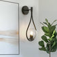 7.87 in. 1-Light Black Modern Globe Wall Sconce with Seeded Glass Shade for Living Room